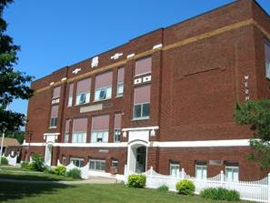 A brick building with white picket fence

AI-generated content may be incorrect.