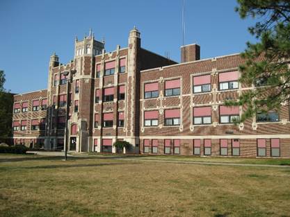 A large brick building with a lawn